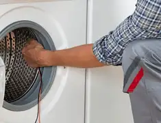 Dryer repair technician diagnosing and servicing a clothes dryer in Anaheim, CA