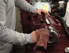 Vacuum repair technician cleaning and servicing a vacuum motor in Anaheim, CA