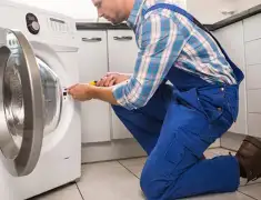 Washing machine repair technician servicing a front-load washer in Anaheim, CA